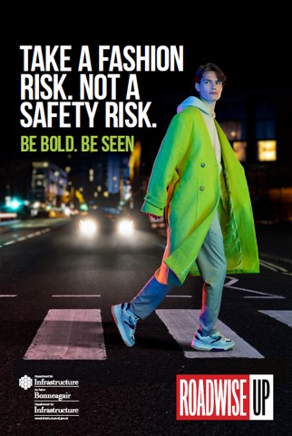Image of a person crossing the road wearing fluorescent clothes, with the caption,'Take a fashion risk. Not a safety risk'
